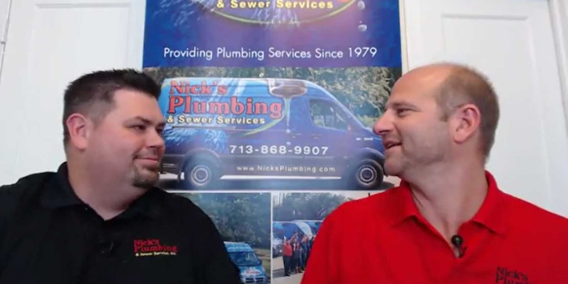Two of Nick's Plumbing Experts in Houston Smiling and Looking at Each Other