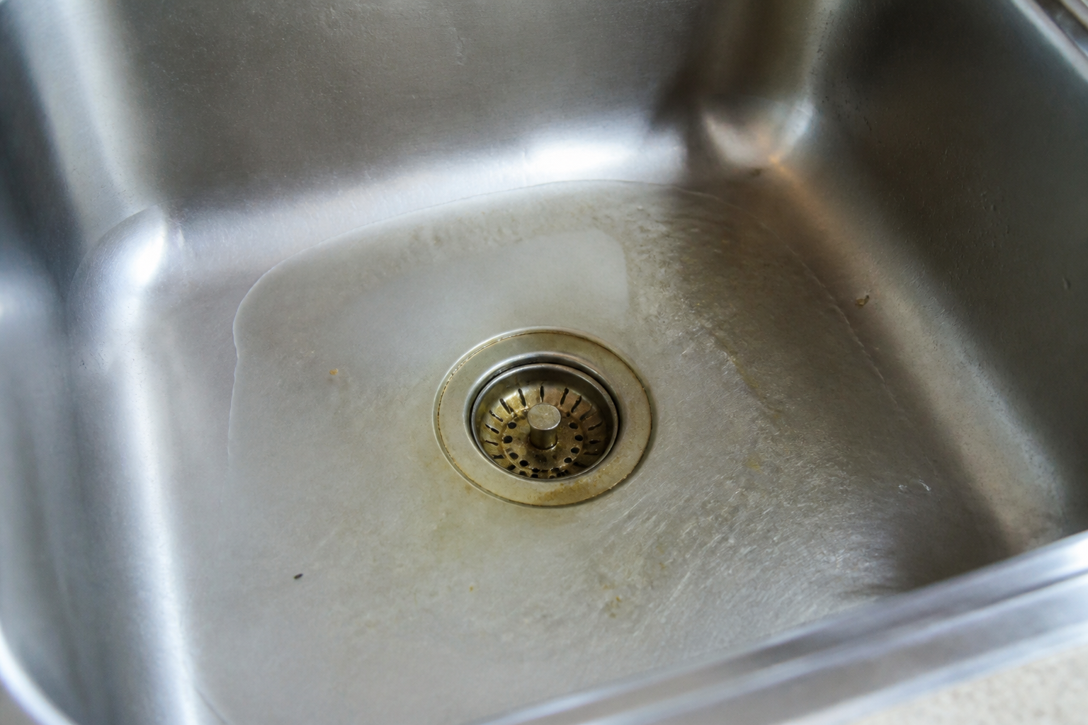 Houston kitchen sink draining slowly after a summer of cookouts and grease buildup