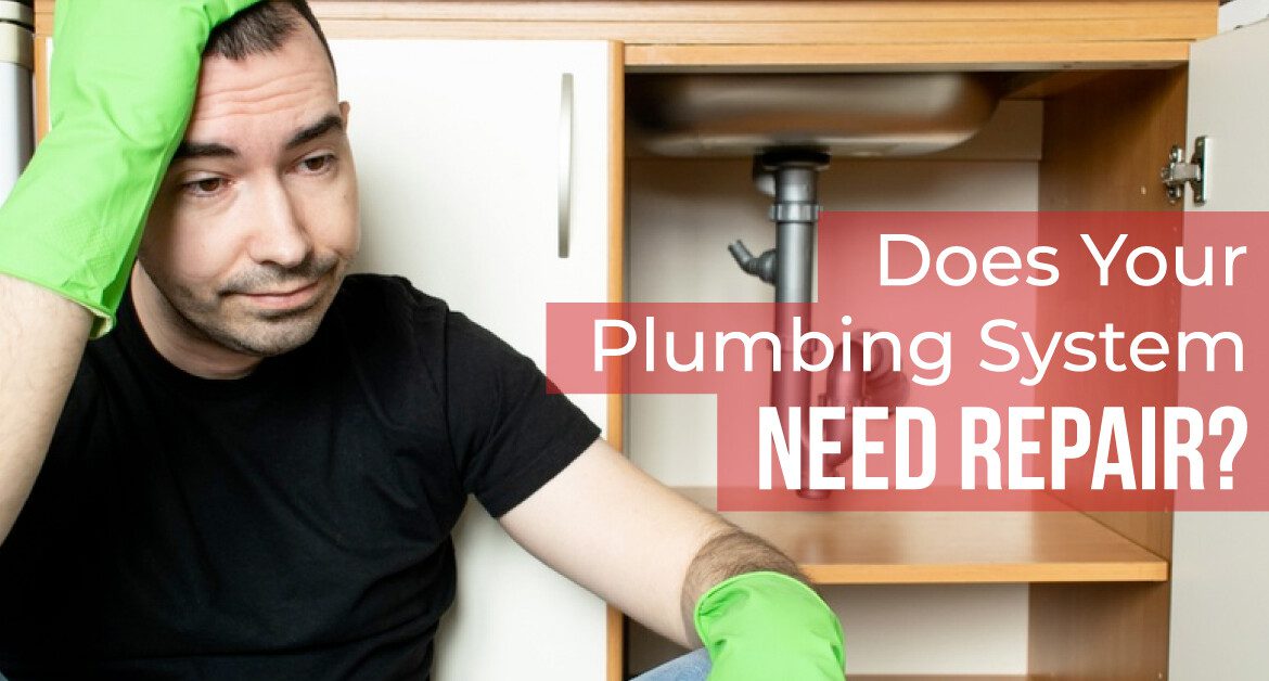 Worried Homeowner Sitting Next to an Under-Sink Pipe